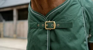 A close-up view of the velcro attachment tabs used to secure a detachable neck piece to a horse turnout rug.