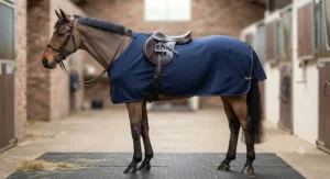 Side view of a shaped fleece exercise sheet for horses showing a snug tail flap and secure fillet string.