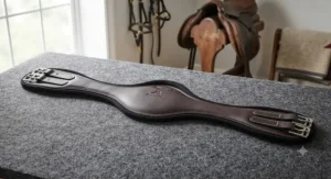 Anatomically shaped budget dressage girth designed to prevent pinching behind the horse's elbow