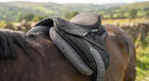 Close-up of a lightweight synthetic affordable endurance saddle showing breathable panels for ultimate horse comfort.