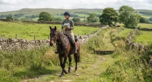 A rider enjoying a TREC competition using a reliable and affordable endurance saddle on a grassy bridleway.