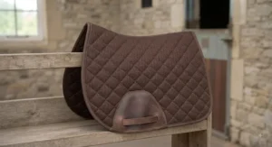 A brown value GP numnah featuring reinforced girth guides and breathable fabric.