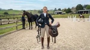 Rider checking their gear with affordable stirrup leathers adjusted for showjumping.